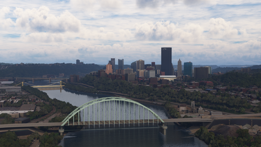 Pittsburgh skyline behind river bridges, including a pale green arch bridge in the foreground