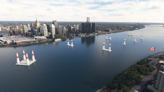 Aerial view of colored air race pylons on the Detroit River with downtown Detroit behind