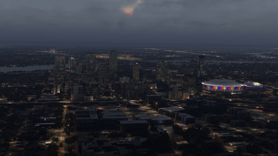 New Orleans downtown skyline and domed stadium after dark, with dfflyerdirect scenery