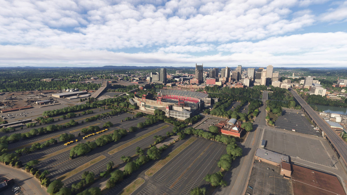 Before: default MSFS scenery, Nashville stadium district and downtown skyline across the river