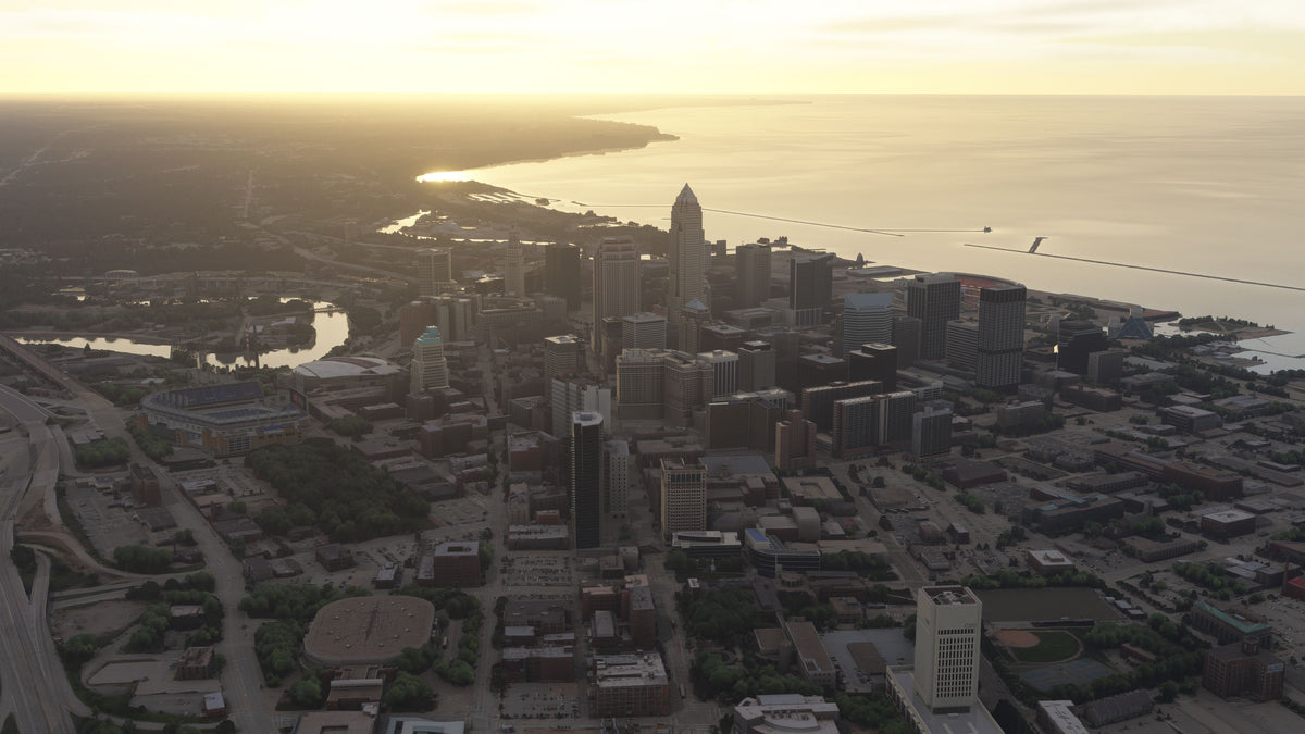 Golden-hour aerial view of downtown Cleveland, the lakefront, and the river winding through the city in Ohio MSFS scenery.