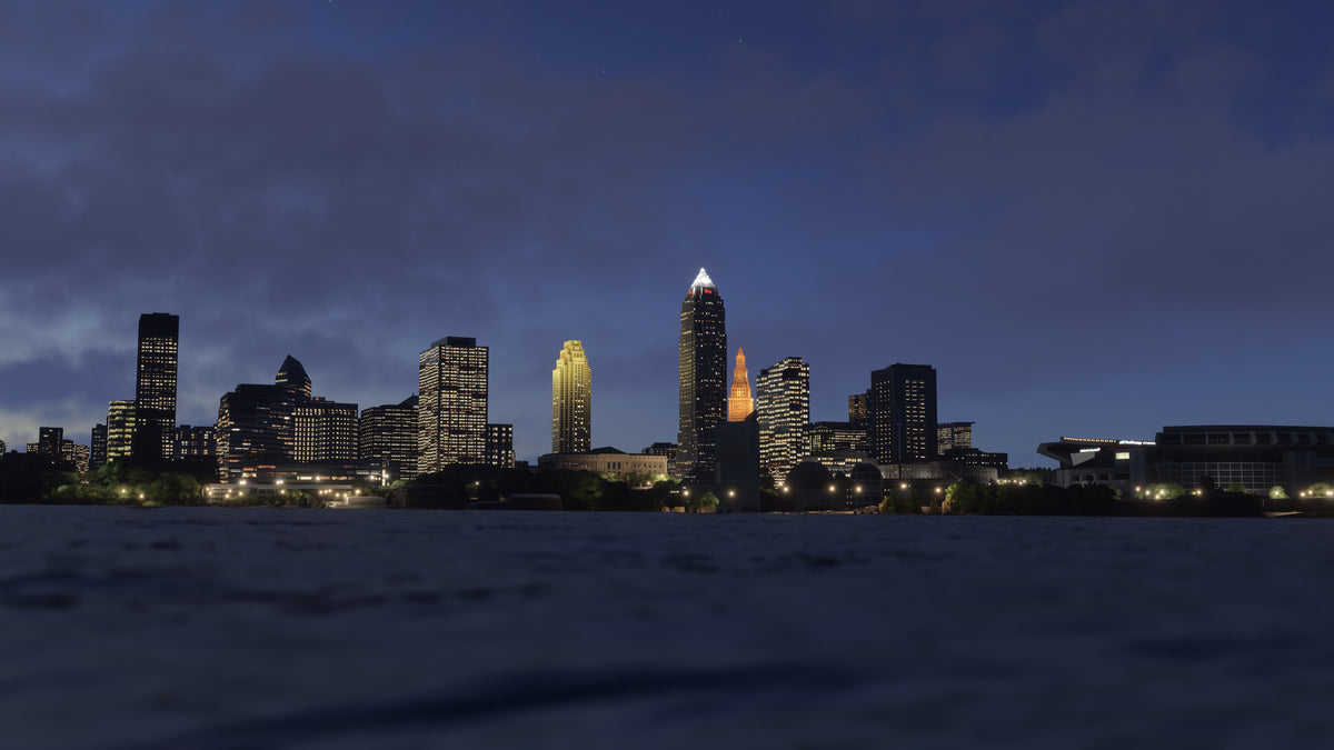 View across the water toward Cleveland's illuminated skyline and waterfront stadium at night in Ohio MSFS scenery.