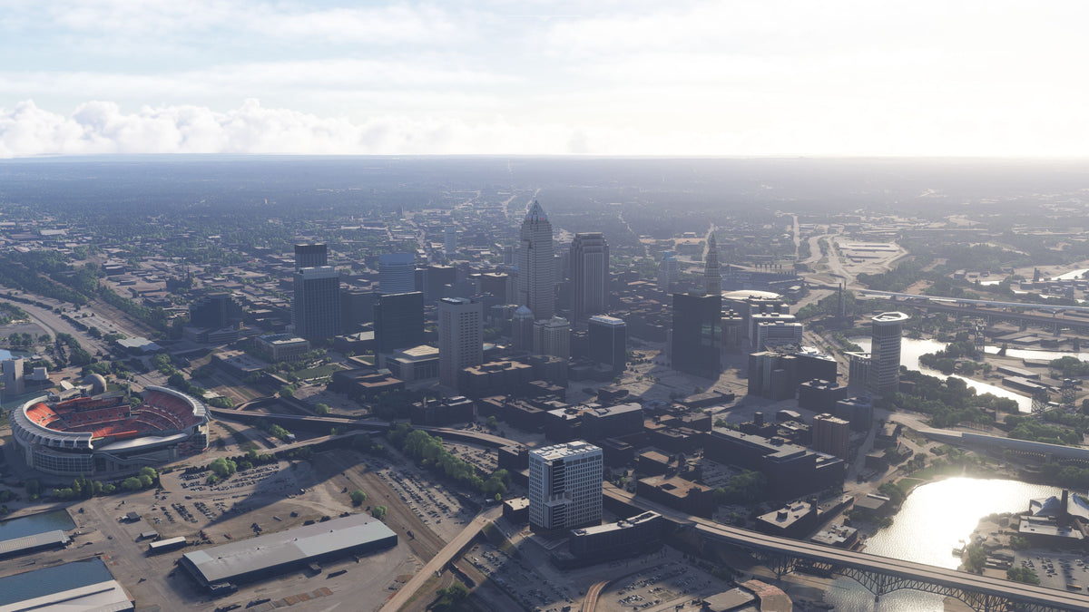Daytime aerial view of Cleveland, Ohio MSFS scenery, with downtown towers, the football stadium, and a river bridge.