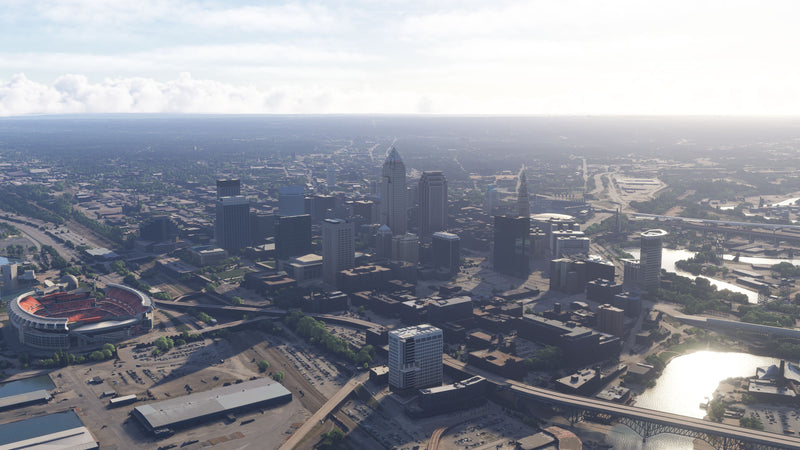 Daytime aerial view of Cleveland, Ohio MSFS scenery, with downtown towers, the football stadium, and a river bridge.