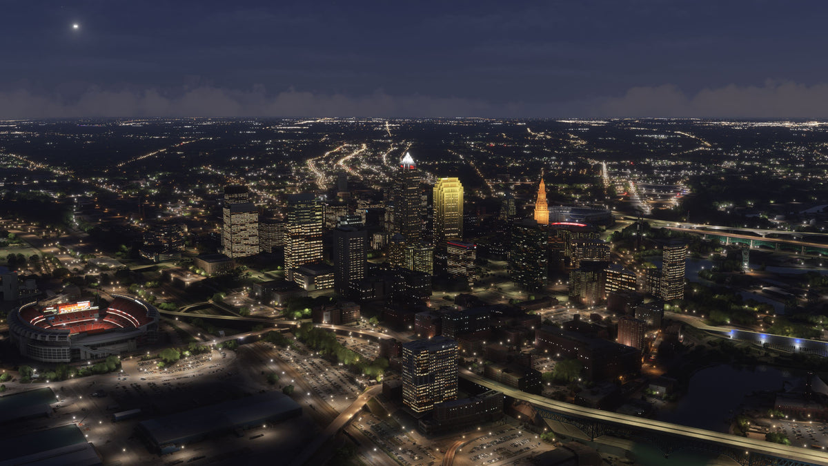 Aerial view of Cleveland, Ohio MSFS scenery at night, with illuminated downtown towers, the football stadium, and river bridges.