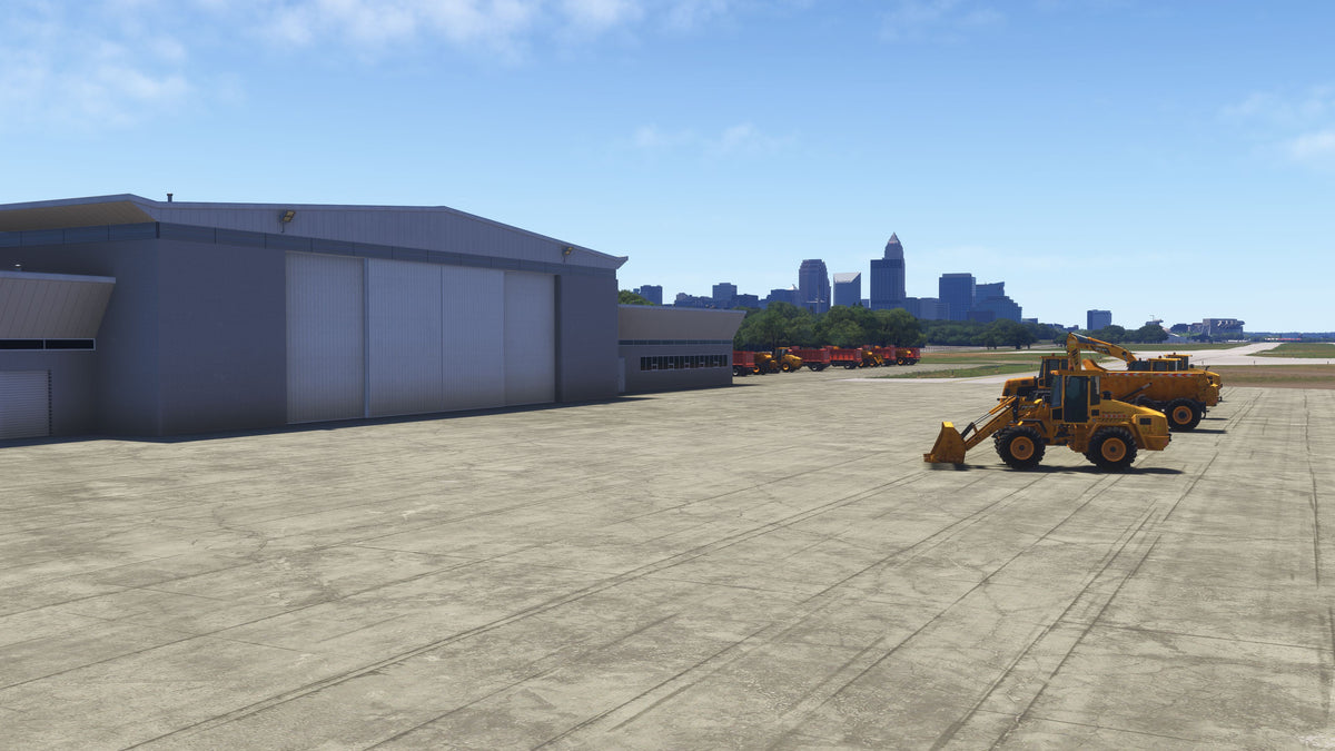 KBKL airport maintenance building with parked loaders, service trucks and pavement detail in daylight in MSFS.