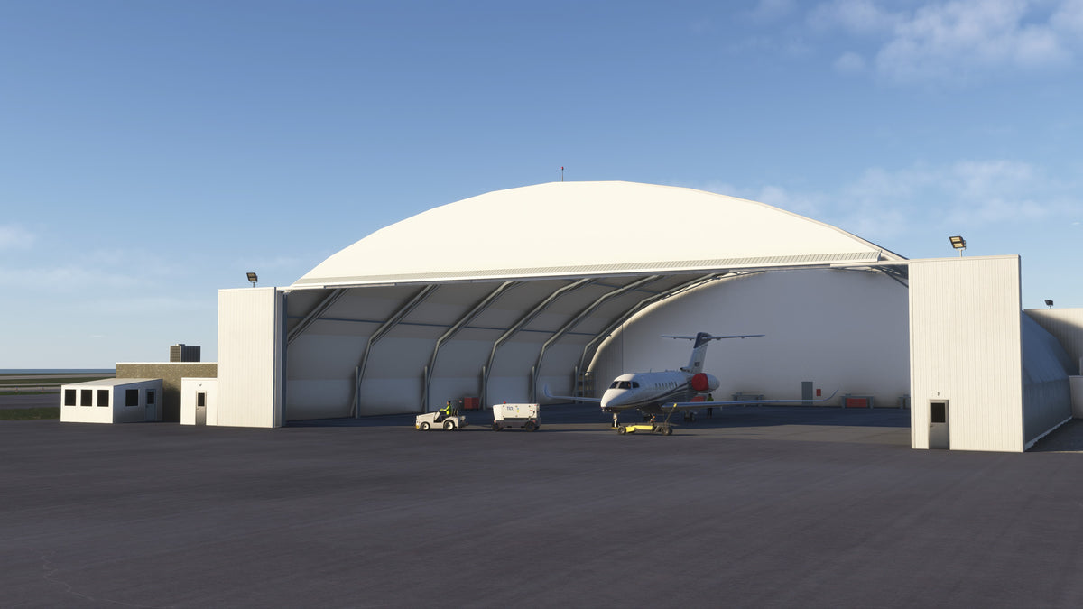 Open arched hangar at KBKL with a business jet, towing equipment and ground service equipment in daylight in MSFS.