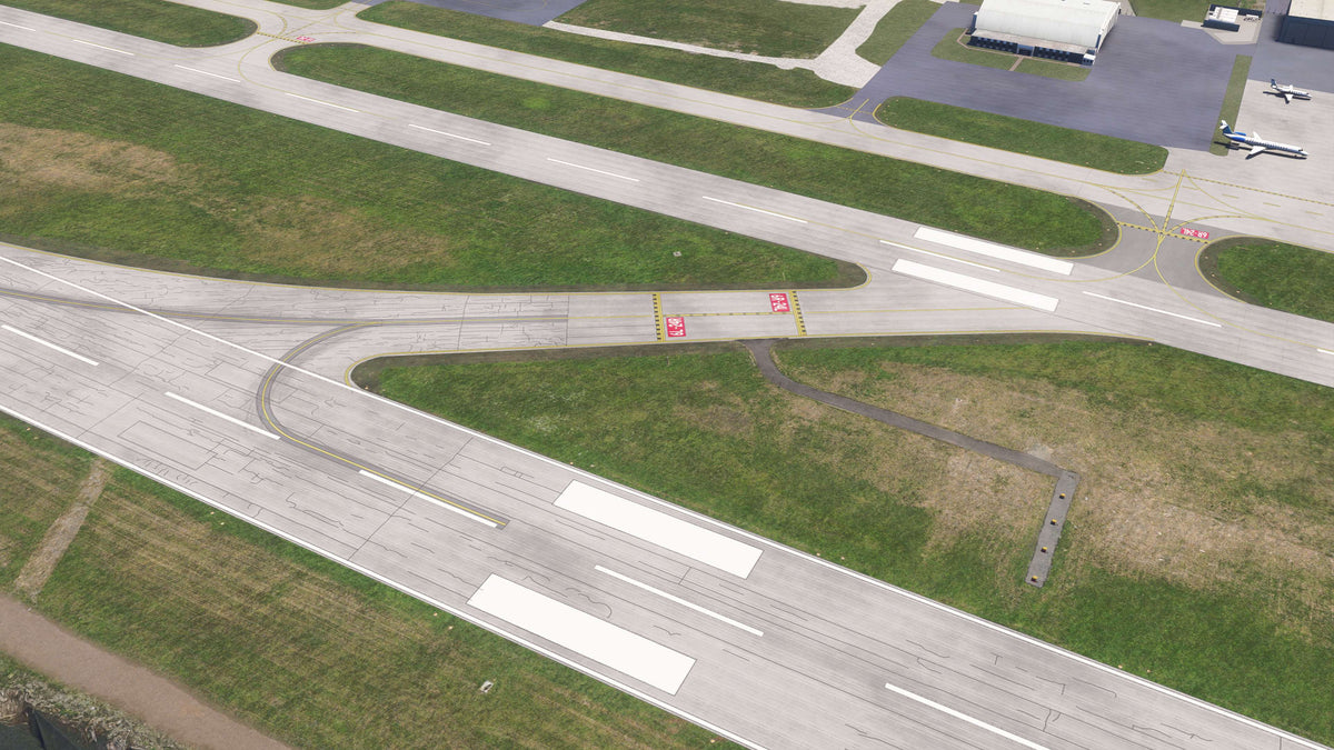 Overhead view of KBKL runway and taxiway connections with holding markings, weathered pavement and grass infields in MSFS.