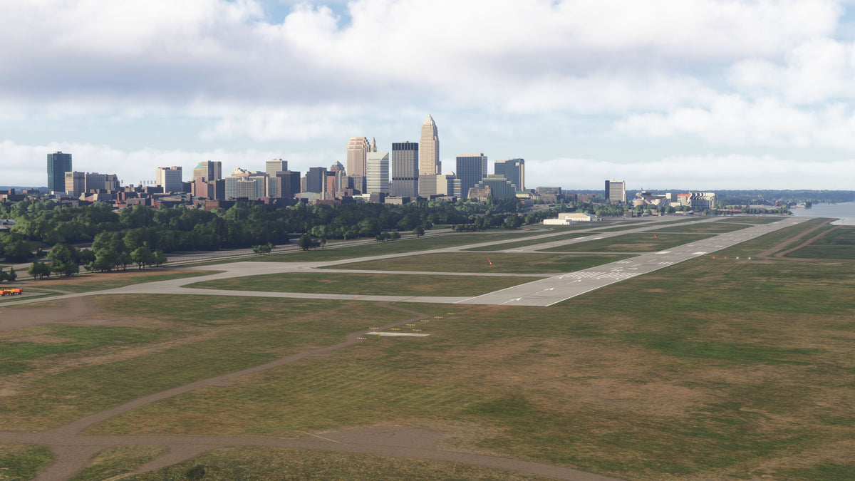 Burke Lakefront Airport runways and taxiways with the Cleveland skyline in the background in daylight in MSFS.