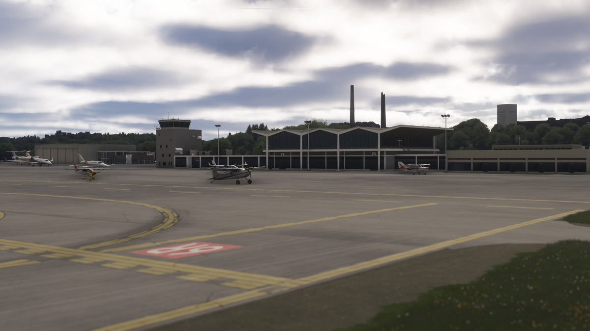 KBKL terminal and control tower across the aircraft apron, with yellow taxiway markings in the foreground in MSFS.