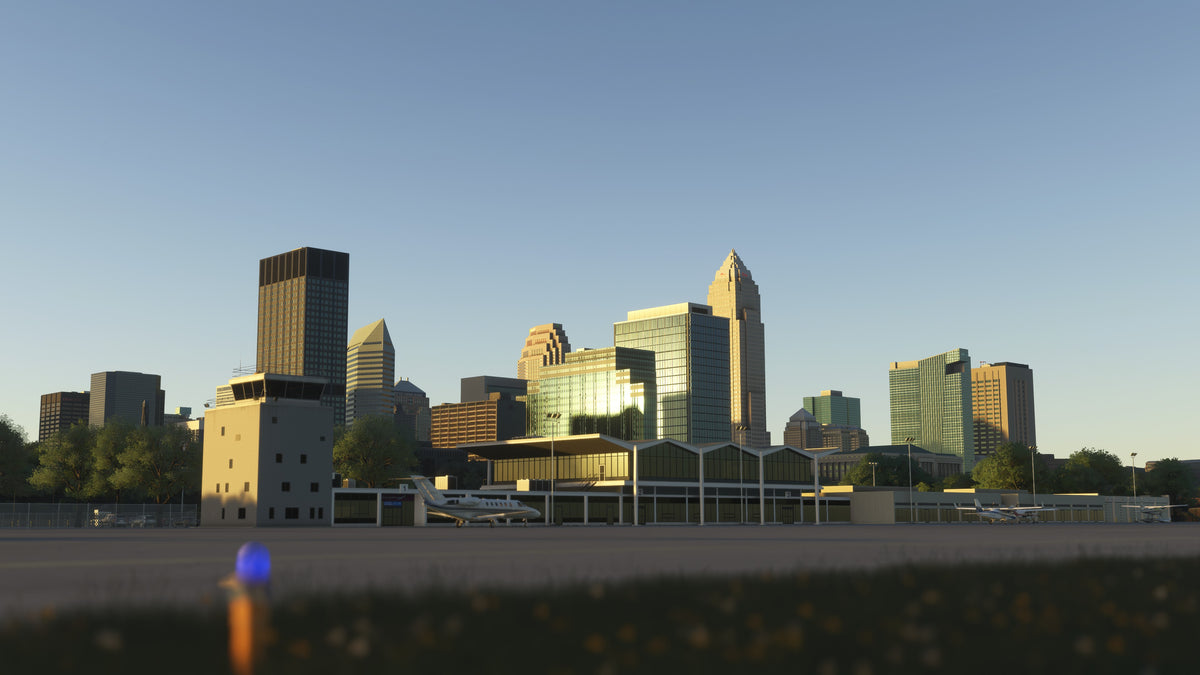 KBKL terminal and control tower in golden-hour light, with parked aircraft and Cleveland buildings behind them in MSFS.