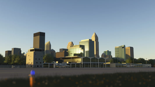 KBKL terminal and control tower in golden-hour light, with parked aircraft and Cleveland buildings behind them in MSFS.