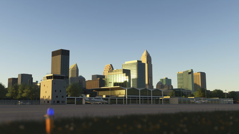 KBKL terminal and control tower in golden-hour light, with parked aircraft and Cleveland buildings behind them in MSFS.