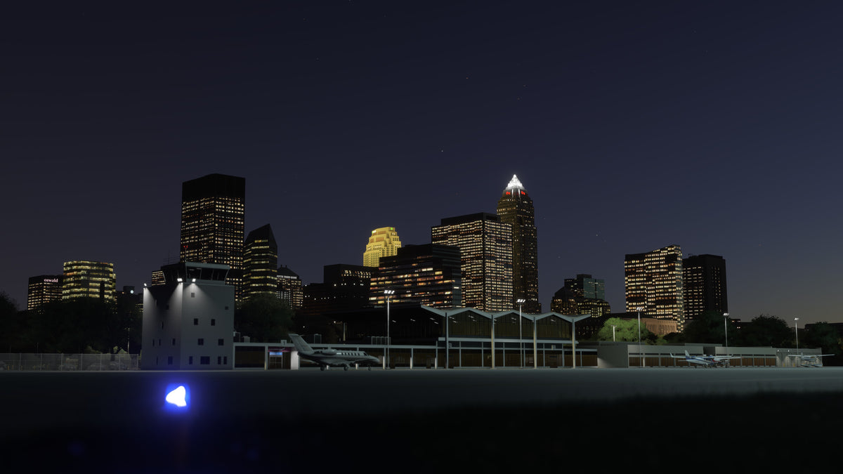 KBKL terminal, control tower and apron lighting beneath the illuminated Cleveland skyline at night in MSFS.